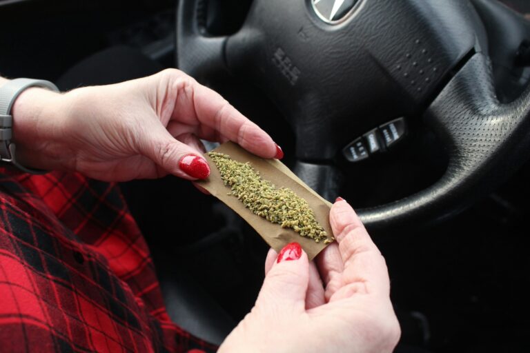 Rolling a joint of marijuana behind the wheel of a car